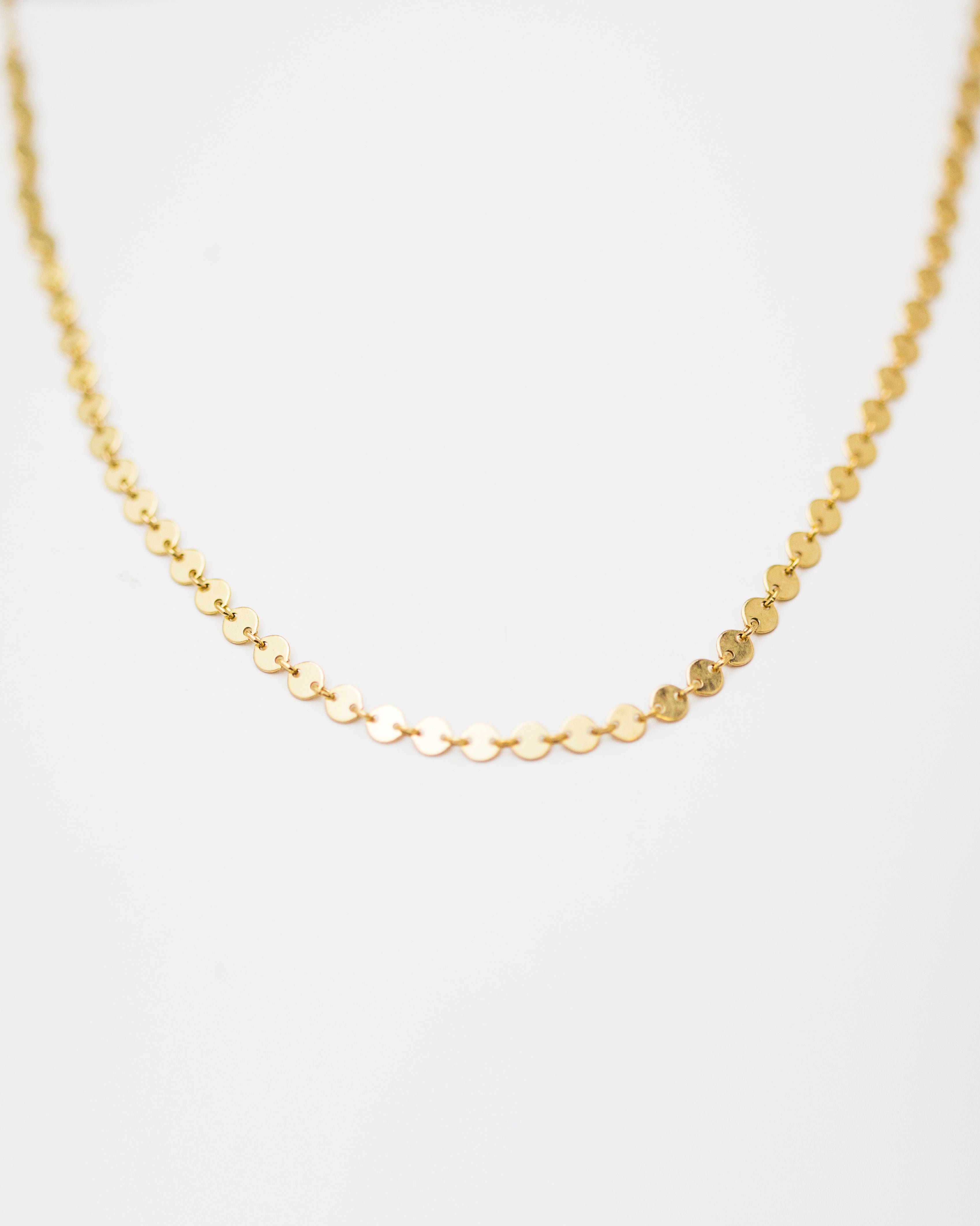 Indulge in the stunning elegance of our Coin Disc Choker, perfect for both a standalone piece or layered with other necklaces for a rich and bohemian look.