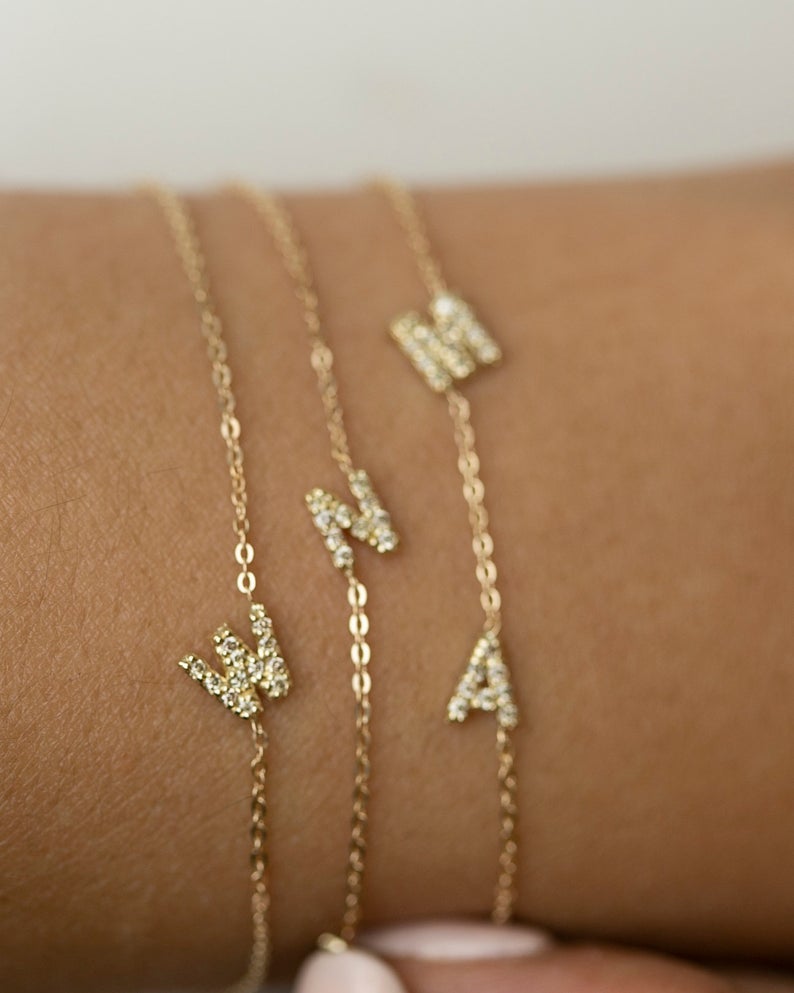 Personalized 14k solid gold mini diamond letter bracelet!

Indulge in understated luxury with our 14k Gold Mini Diamond Initial Bracelet, a delicate yet dazzling addition to your daily wardrobe. Adorned with a sparkling diamond and customizable with your choice of uppercase alphabet initial, this bracelet adds a touch of elegance and personalization to any outfit. The perfect choice for the woman who values simplicity and sophistication in her everyday style.

Great as a gift for special someone or for your