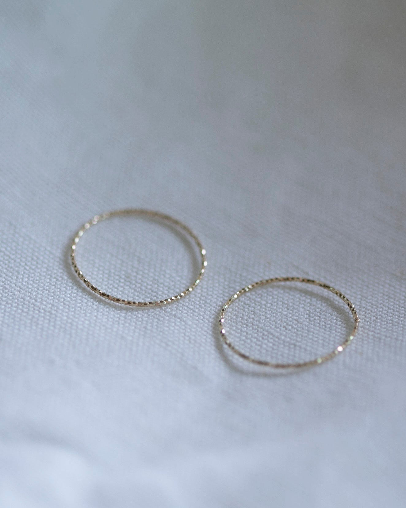 Crafted from 14k gold and featuring a diamond-cut design, these stacking rings offer a dainty and simplistic look that is perfect for everyday wear.