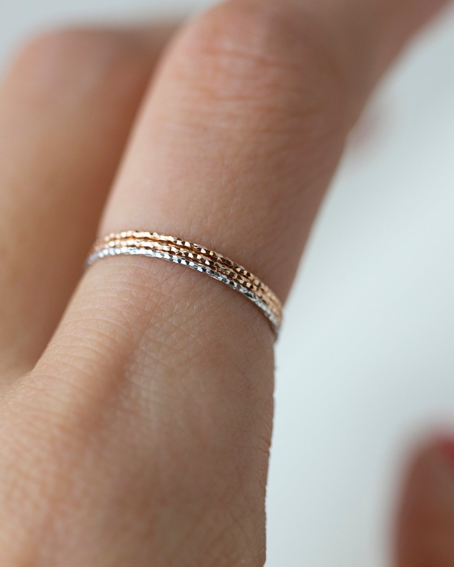 Crafted from 14k gold and featuring a diamond-cut design, these stacking rings offer a dainty and simplistic look that is perfect for everyday wear.