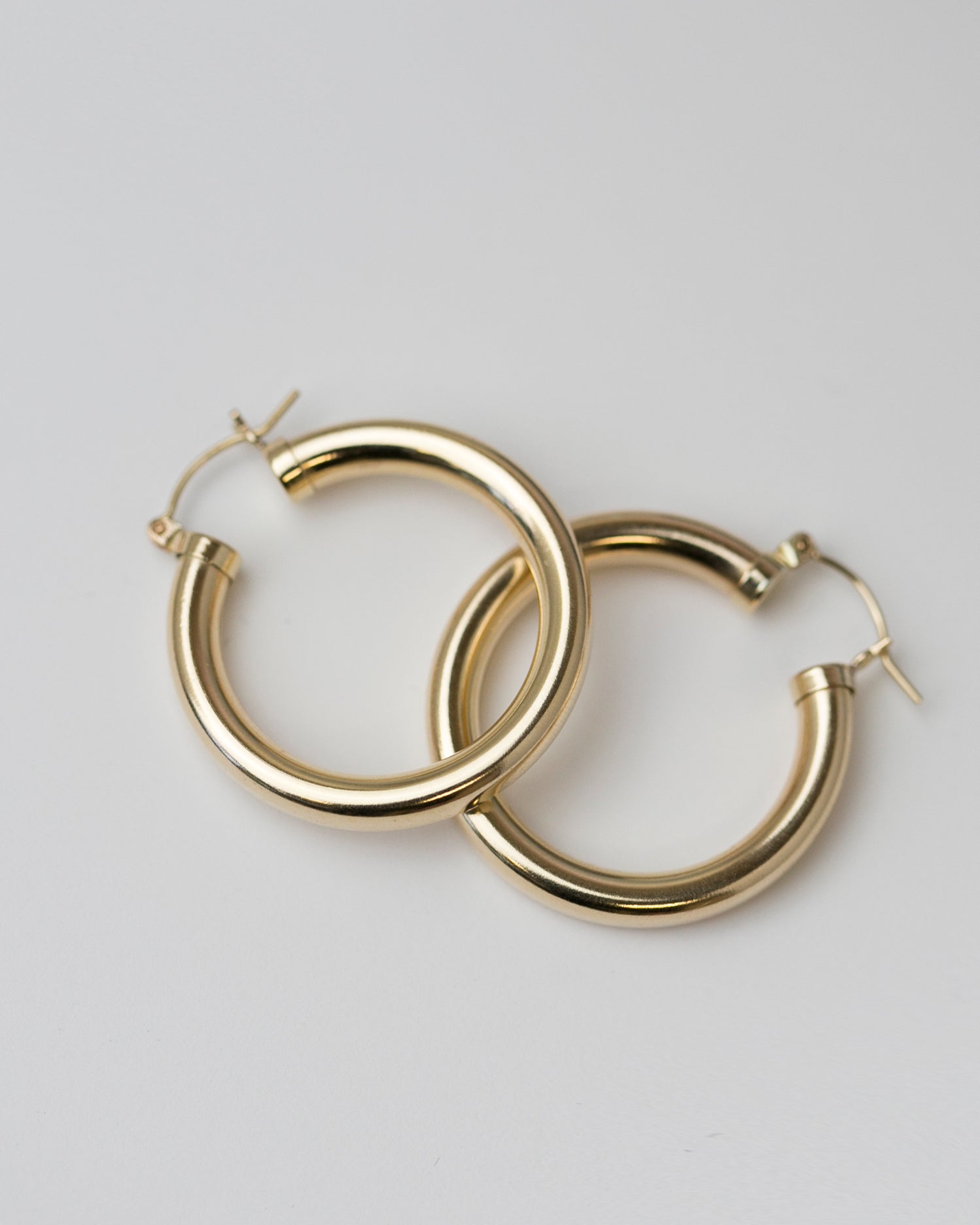 Expertly crafted from high-quality gold, these Chunky Hoop Earrings are a timeless addition to your jewelry collection. The classic design ensures versatility and elegance for any occasion, making them a must-have staple piece in your wardrobe.