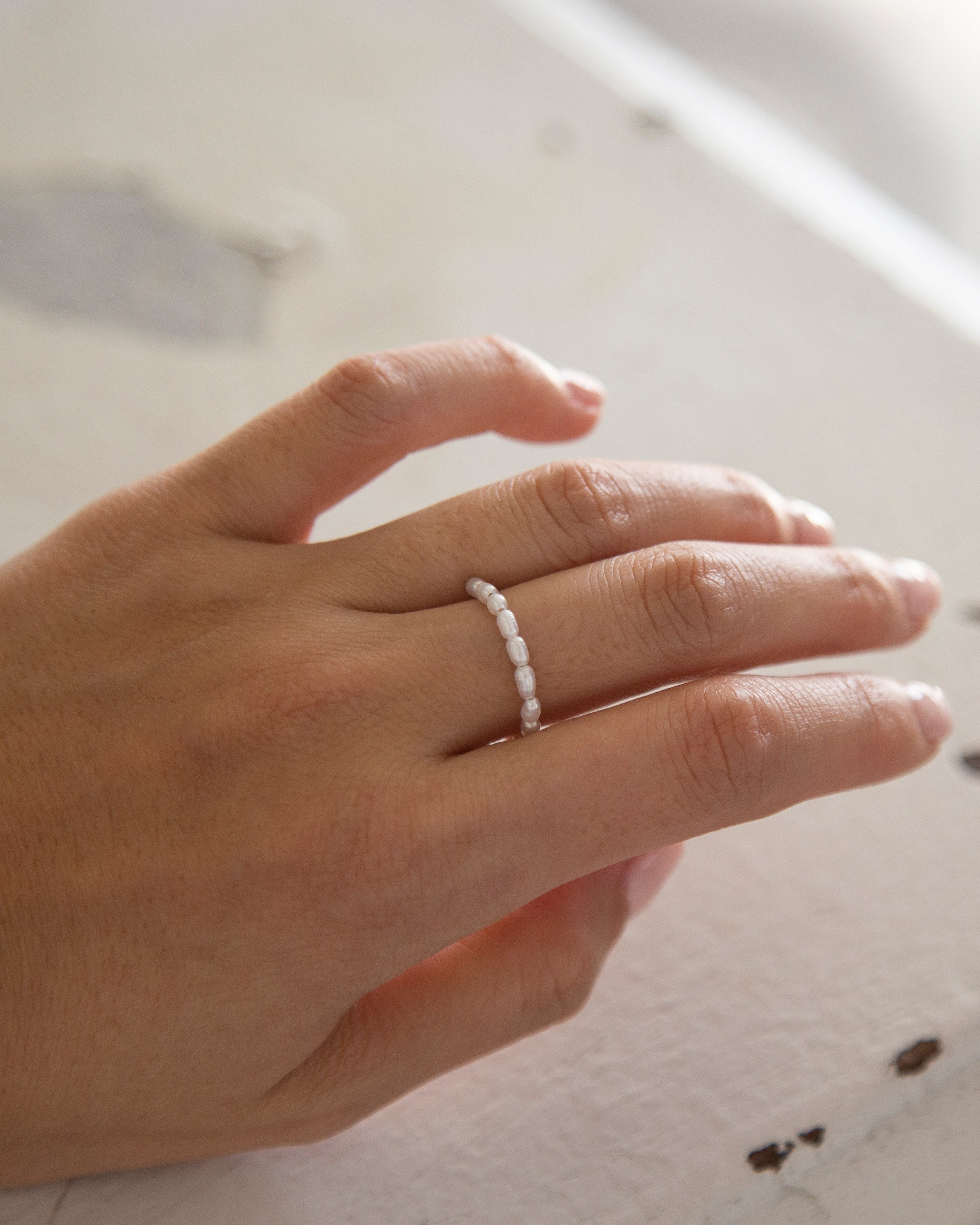 Baby Lotus Pearl Ring
Made with mini rice shape fresh water pearls and gold filled bead on a
comfy stretchy elastic band. Baby lotus pearl ring will be the perfect addition to your ring stack!