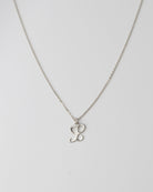 Cursive Letter Charm Necklace. Perfect wearing alone or layering with your favorite necklaces.