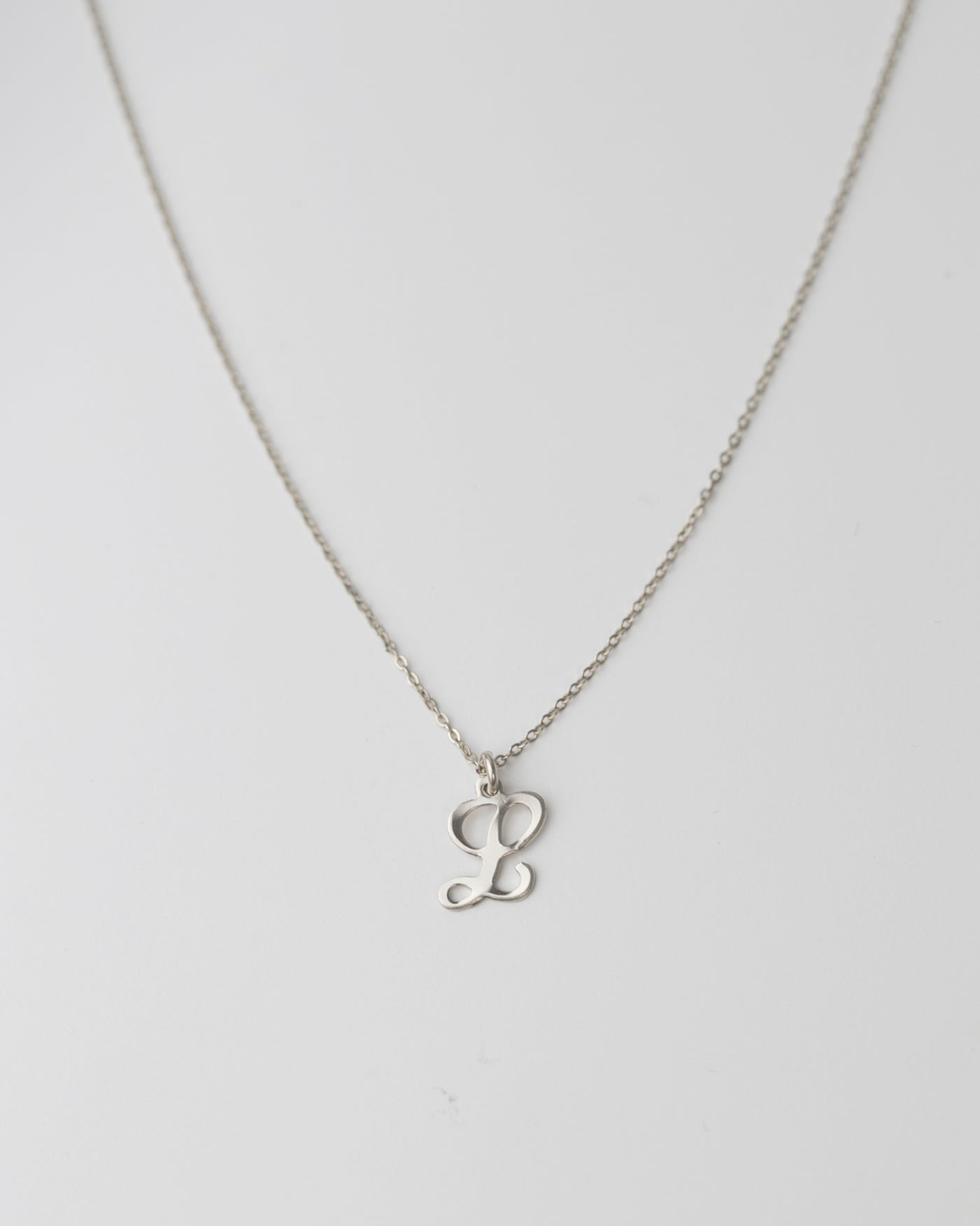 Cursive Letter Charm Necklace. Perfect wearing alone or layering with your favorite necklaces.