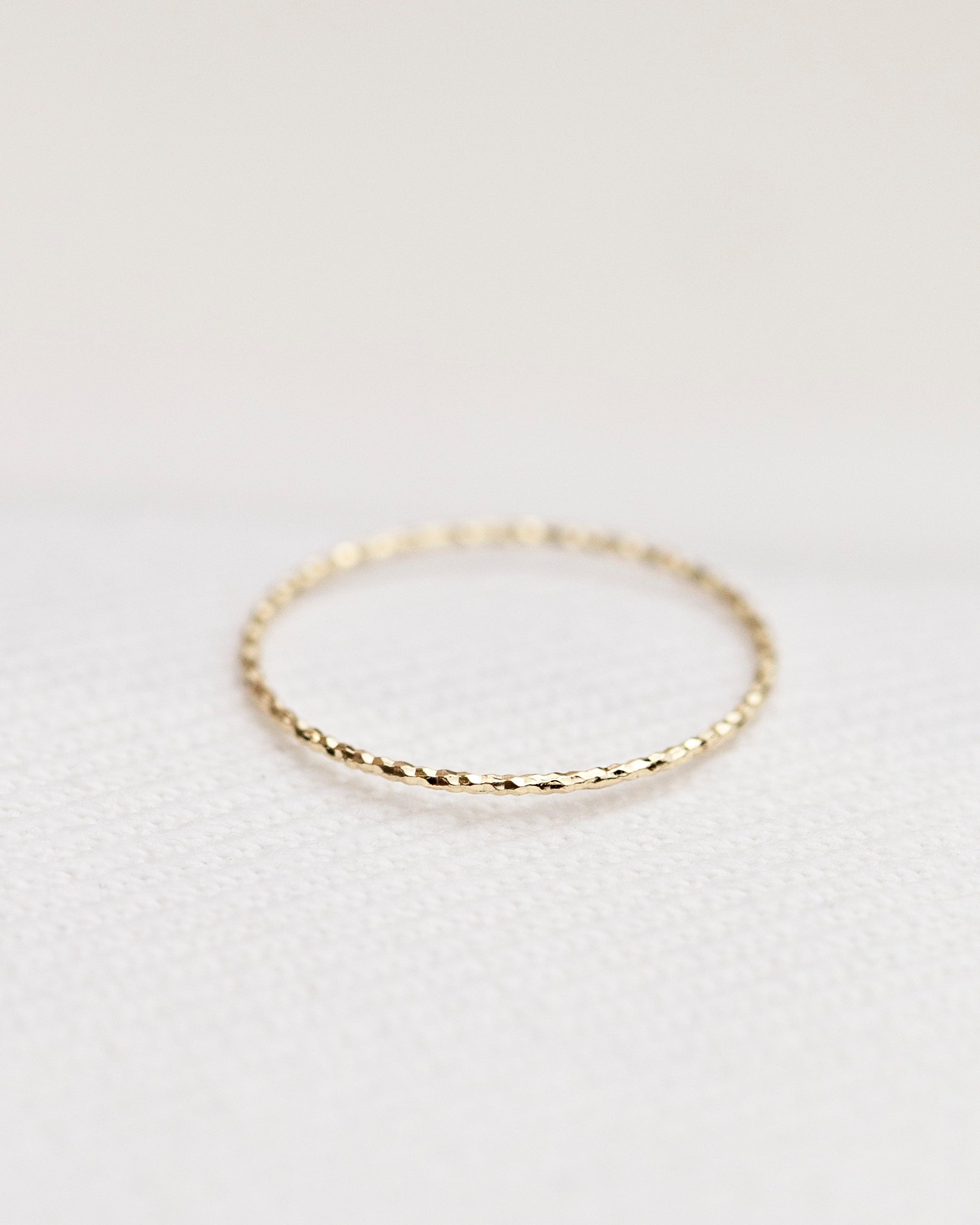 Crafted from 14k gold and featuring a diamond-cut design, these stacking rings offer a dainty and simplistic look that is perfect for everyday wear.