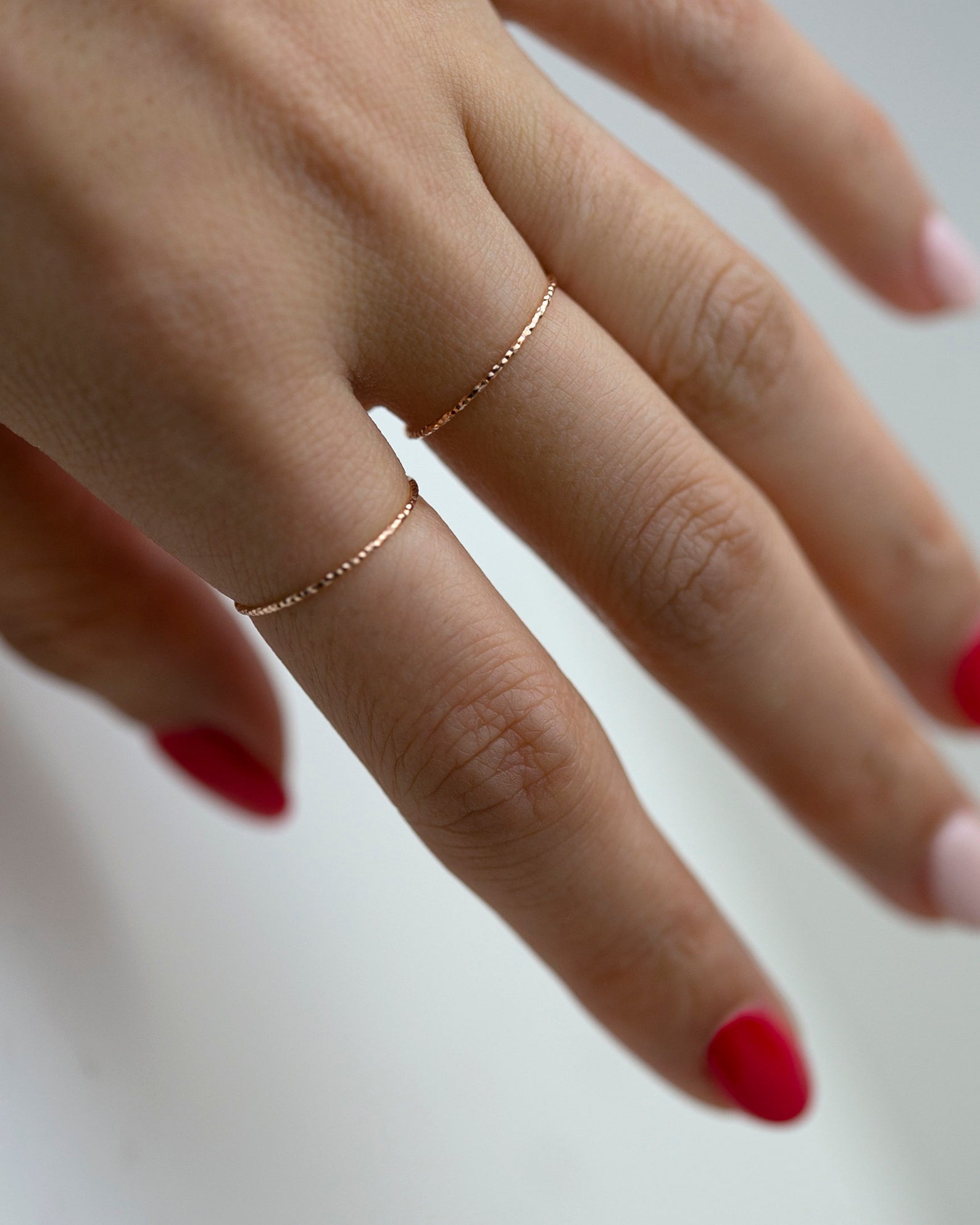 Crafted from 14k gold and featuring a diamond-cut design, these stacking rings offer a dainty and simplistic look that is perfect for everyday wear.