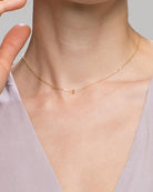  a delicate gold bead necklace l